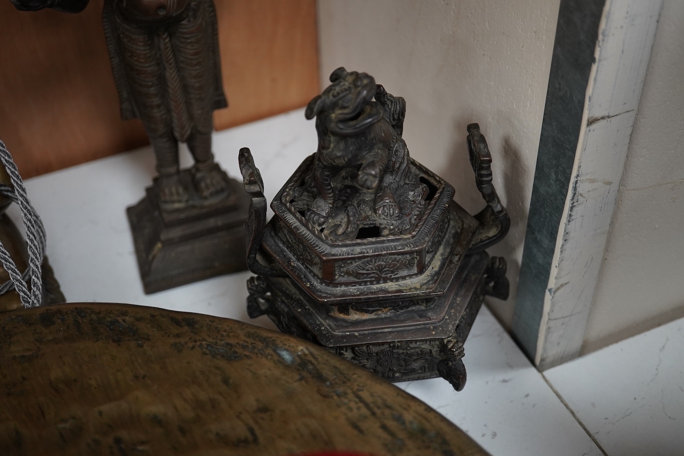 A group of four south east Asian cast bronzes and a gong with mount and beater, 40.5cm
